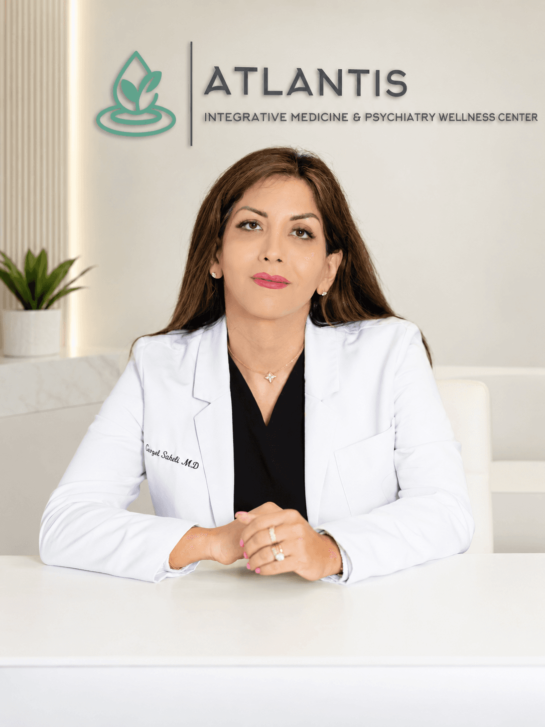 Gezel Saheli, MD, seated at Atlantis Wellness Centers